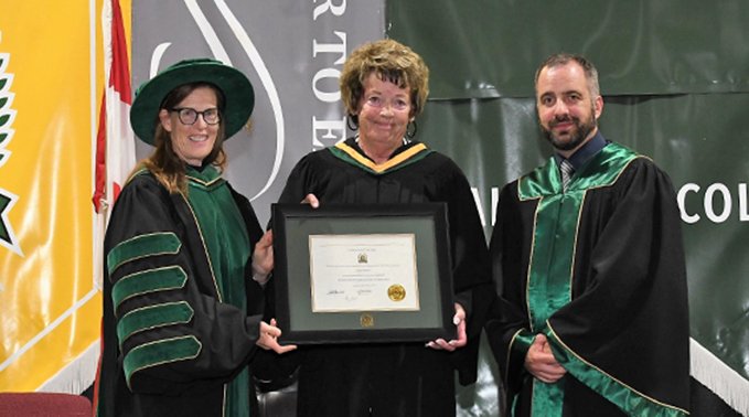 Dr. Alice Wainwright-Stewart, Lakeland's president's and CEO, and Adam Water, chair of Lakeland Board of Governors, presents Judy Sweet with a Honorary Bachelor of Agriculture Technology Degree.