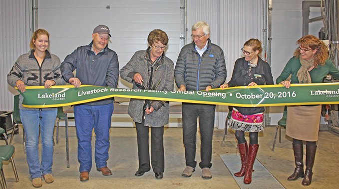 Judy Sweet cuts the ribbon, officially opening the G.N. Sweet Livestock Research Facility.