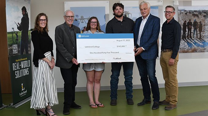 Jerru Bouma and Ken Knowles present a cheque to Lakeland staff and students.