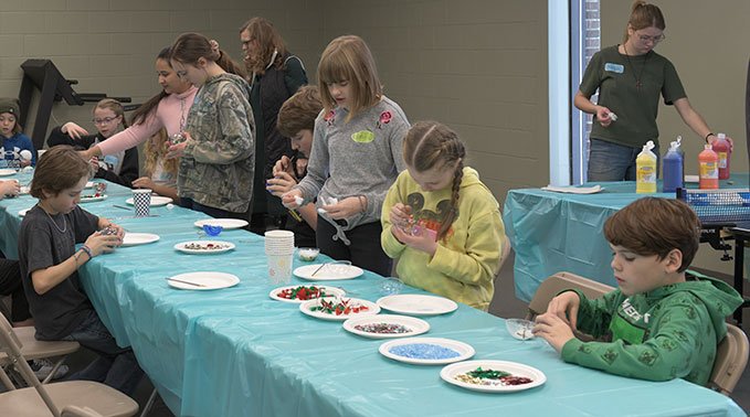 A group of kids work on some crafts introduced by Lakeland College students.
