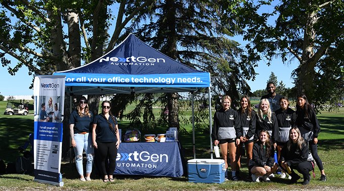 A group of Lakeland College student-athletes under the NextGen tent at the 2022 tournament