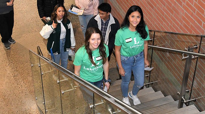 Two Lakeland College student ambassadors lead a group of guests during Open House.
