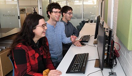 IT staff help students at computer stations
