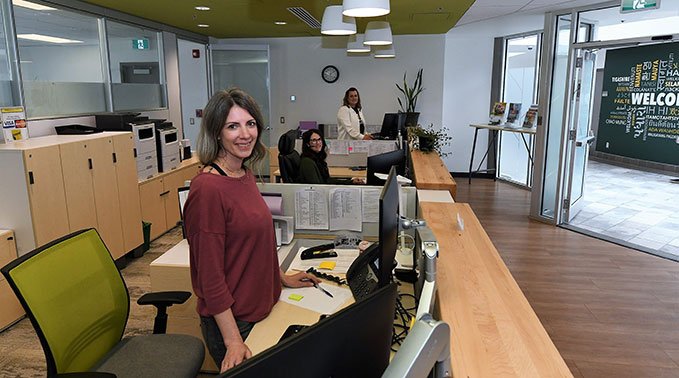 Student services staff at their desks, side-by-side ready to greet students and visitors.