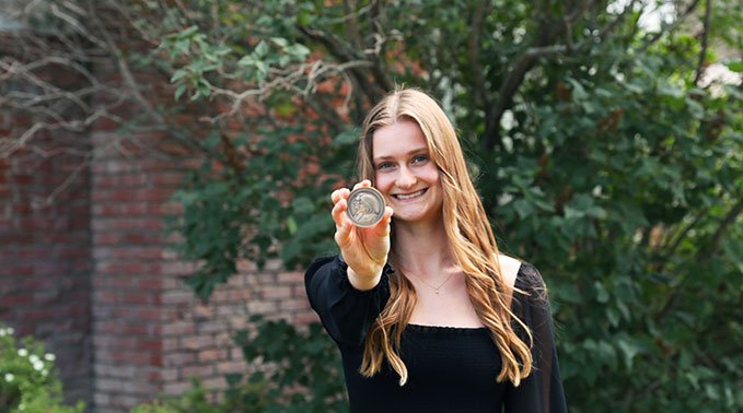 Hannah Tataryn proudly holds out her Governor General's Academic Medal.