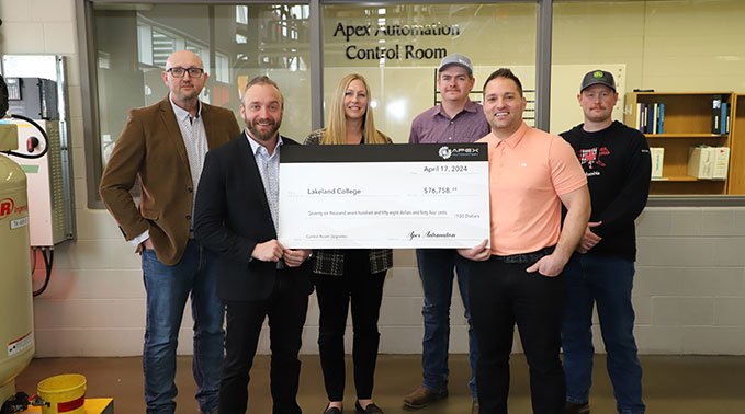 Representatives from Apex Automation present Lakeland College a $76,758 cheque in front of the newly names Apex Automation Control Room.