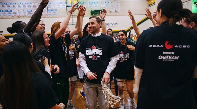 Chris King walks through a crowd of cheering students.