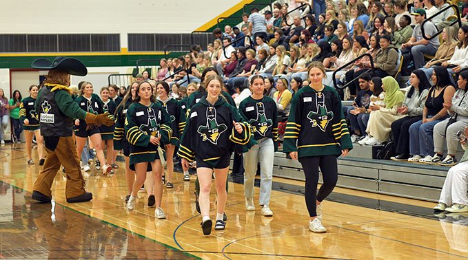 The Rustlers Women's Hockey Team arrives at the pep rally that kicked off the academic year.