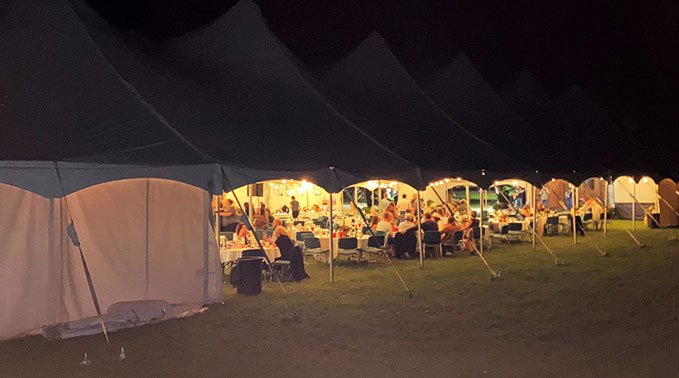 Feast on the Farm tent shines through the night