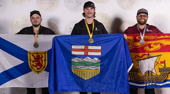 James holding the Alberta flag after winning gold