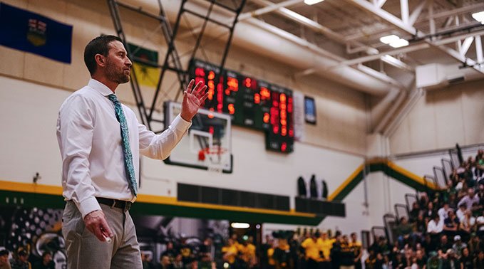 Lakeland Rustlers women's basketball coach, Chris King, coaches from court side..