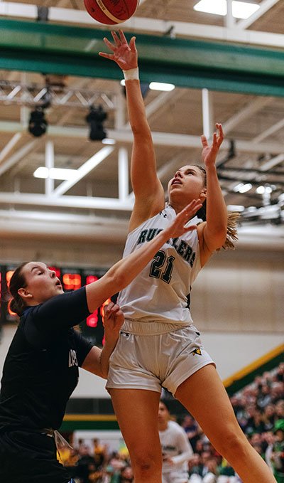 Lakeland Rustlers women's basketball player #21 performs a layup.