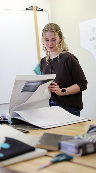 Caydence Lundgren fkips through a interior design look book.