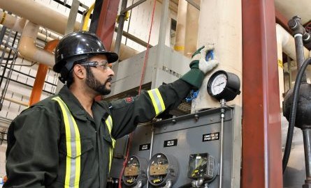 Man checking instrument panels in a steam lab