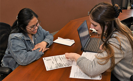 Two students working on paperwork together