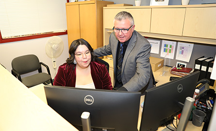 Student and instructor at a desk