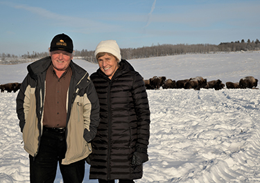 Armin and Rita Mueller with bison herd
