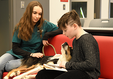 Student reading to dog