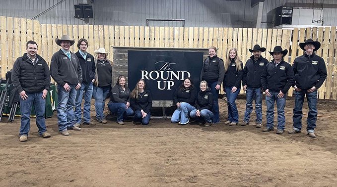 Round Up team pose with their sign