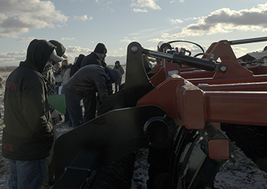 Students get a closer look at the workings of one of the pieces of machinery at the demo
