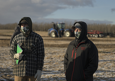 Students watch the tillage equipment in action.