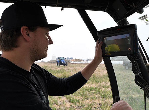 Lakeland student in a tractor using monitor equipment