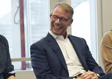 Jeremy Wakefield smiling with fellow alumni at 2020 university transfer alumni social