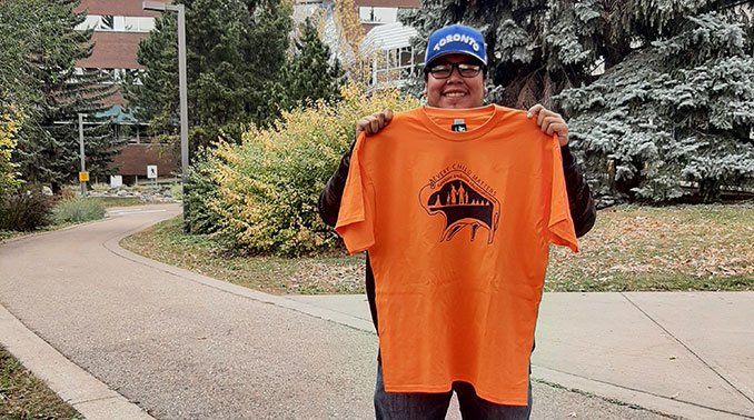 Levi holding his designs