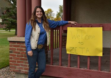 Codie Lee Yasienuk, stands by the dorm she stayed in as a student