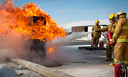 Students extinguishing a fire in winter