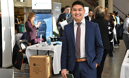 Person in business attire standing with professional mixer in background