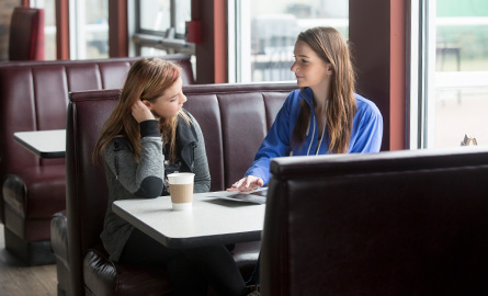 Two people sitting together talking