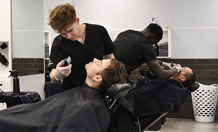Student giving a beard trim in the salon