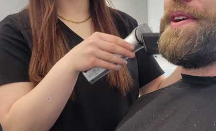 student trimming beard