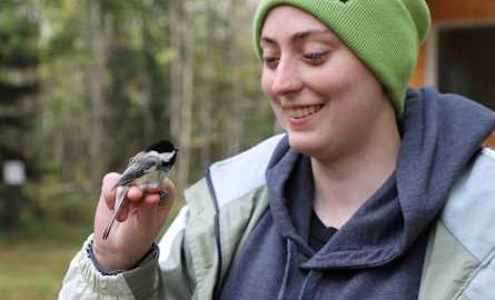 student holding chickadee