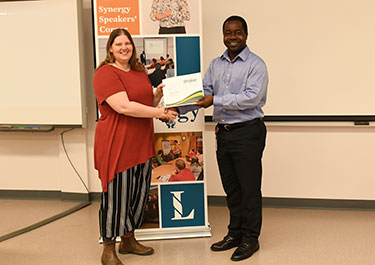 Angela receives her Synergy Speakers Corner certificate from Ben Acquaye, chair and instructor of Lakeland's School of Business.