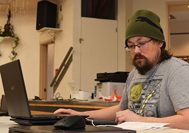 Dan Kinaschuk completes accounting tasks on his computer during one of Lakeland's free tax clinics