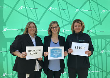 Nicole Clow, Saskatchewan Summer Games manager (left), Hawes and Cindy Rekimowich, Saskatchewan Summer Games host society vice-chair (right) announce $140,000 through Co-op Community Spaces program for the resurfacing of the track at Armstrong Field in Lloydminster, in June 2019