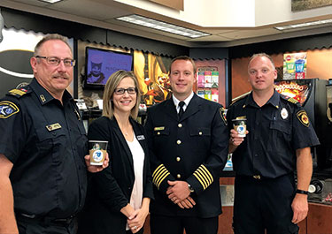 Norm Namur of the Lloydminster Rescue Squad, Hawes, former fire chief Jordan Newton of Lloydminster Fire Department (centre right), and deputy fire chief Aaron Buckingham of the RM of Brittania (right) gathered in August 2018 to launch Lloyd Co-op’s Cup of Caring program.