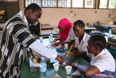 Ben Acquaye (left) interacts with VETA students during a class