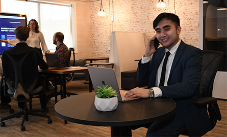 Student taking a business call in cafe setting