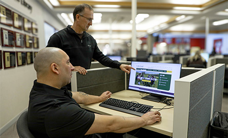 Student and instructor working on a computer