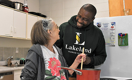 Lakeland student laughing with a child in a wheelchair
