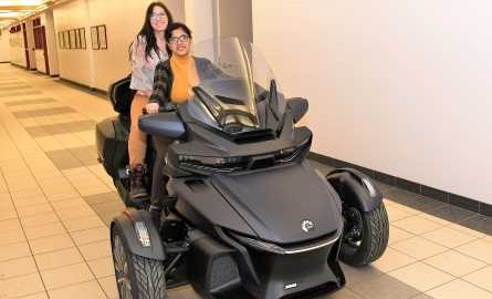 students on a 3-wheel motobike