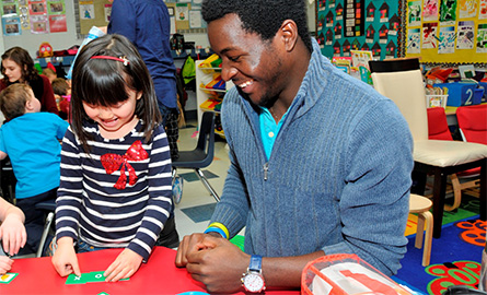 Student helping a child in the classroom