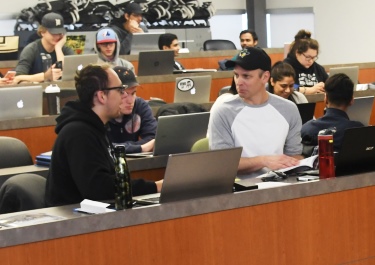 Mizera engages with one of his classmates during a lecture. Earning a 3.5 or higher landed Mizera on the 2018 Dean's list.