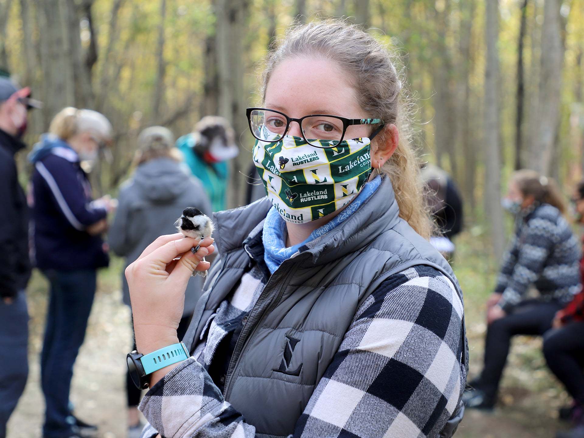 A student handles a bird