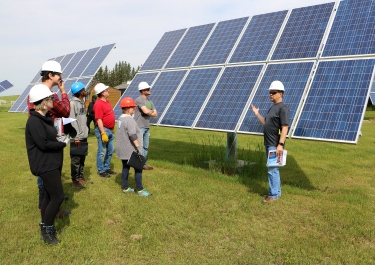 Tozer instructs a group of renewable energy and conservation students at the Renewable Energy Learning Centre
