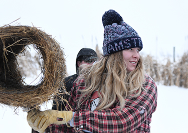 A Lakeland College environmental sciences student holds the nesting tunnel.