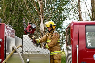 Lakeland College Firefighter Training student learning how to operate a fire truck